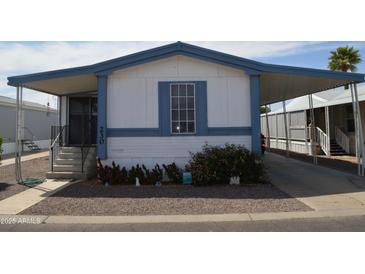 Charming home featuring a blue and white exterior, covered parking, and well-maintained landscaping at 2650 W Union Hills Dr # 230, Phoenix, AZ 85027