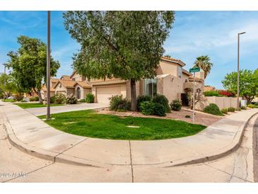 Charming home with a well-maintained lawn, mature trees, and a tile roof on a sunny corner lot at 3832 N Gallatin --, Mesa, AZ 85215