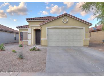 Charming single-story home with a well-maintained front yard, tile roof, and attached two-car garage at 40054 W Tamara Ln, Maricopa, AZ 85138