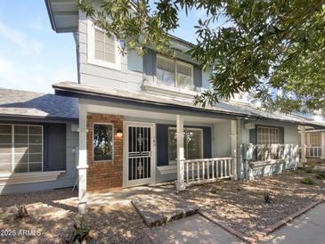 Charming two-story home with a cozy front porch and brick accents at 10101 N 91St Ave # 162, Peoria, AZ 85345
