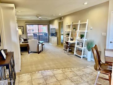 Inviting living room with a balcony, offering a cozy seating area and a stylish workspace at 12222 N Paradise Village Pkwy # 321, Phoenix, AZ 85032