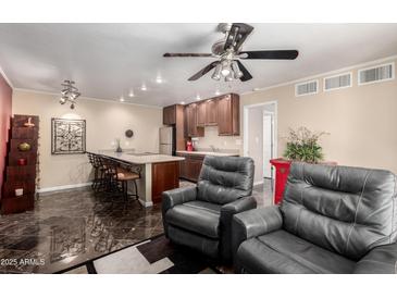 Open-concept living area with a kitchen, seating, and modern finishes at 1440 N Idaho Rd # 2053, Apache Junction, AZ 85119