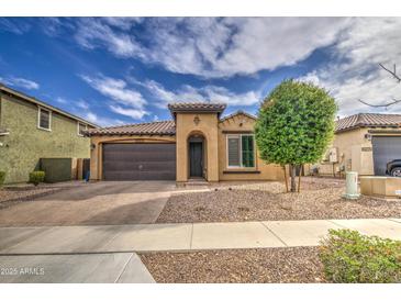 Charming single-story home featuring a two-car garage and desert landscaping, offering a low-maintenance lifestyle at 14413 W Dahlia Dr, Surprise, AZ 85379