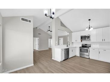 Bright kitchen featuring white cabinets, stainless steel appliances, and modern fixtures at 2234 W Mohawk Ln, Phoenix, AZ 85027