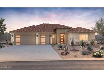 Stunning single-story home showcasing a three-car garage, desert landscaping, and inviting modern entry at 27046 W Rockwood Dr, Buckeye, AZ 85396
