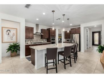Modern kitchen with stainless steel appliances, a large island with seating, and pendant lighting at 3945 E Cherry Hills Dr, Chandler, AZ 85249