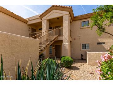 Two-story condo building featuring desert landscaping and a private stairwell leading to the second floor units at 9253 N Firebrick Dr # 206, Fountain Hills, AZ 85268