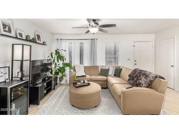 Inviting living room featuring a comfortable sectional sofa, stylish decor, and abundant natural light at 1645 W Baseline Rd # 2176, Mesa, AZ 85202