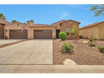 Beautiful single-story home with a three-car garage and desert landscaping for low maintenance at 16911 W Palm Ln, Goodyear, AZ 85395