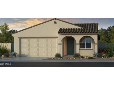 Charming single-story home featuring a two-car garage, arched entryway, and desert-friendly landscaping at 17612 W Georgia Ave, Litchfield Park, AZ 85340