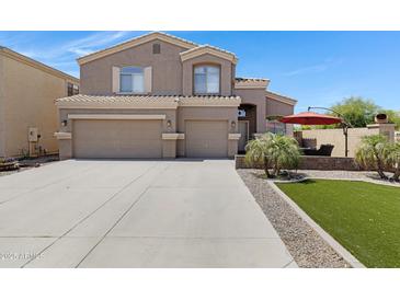 Charming two-story home featuring a spacious three-car garage and well manicured lawn and backyard patio at 19616 N Toya St, Maricopa, AZ 85138