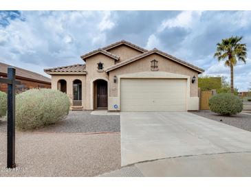 Charming single-story home with desert landscaping and a two-car garage in a quiet neighborhood at 1979 N Vista Ln, Casa Grande, AZ 85122