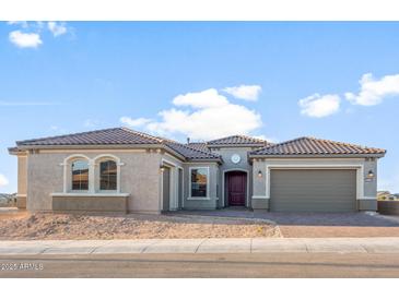 Stunning single-story home featuring a tile roof and three-car garage at 26696 W Siesta Ln, Buckeye, AZ 85396