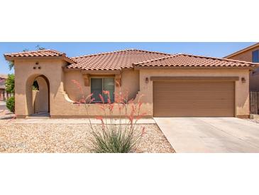 Charming single-story home featuring a terracotta tile roof and desert landscaping for low maintenance living at 3107 S 74Th Ln, Phoenix, AZ 85043