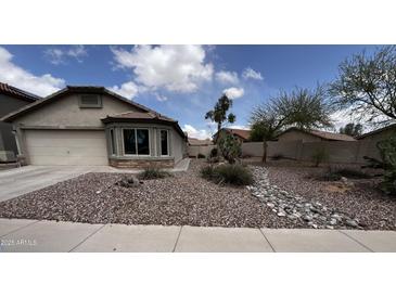 Charming single-story home with desert landscaping and a cozy bay window at 41580 W Sunland Dr, Maricopa, AZ 85138