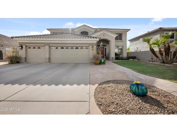 Stunning two-story home with a three-car garage, meticulously landscaped front yard, and charming curb appeal at 630 S Boulder Ct, Gilbert, AZ 85296