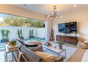 Cozy living area with large windows, comfortable seating, and a serene view of the outdoor space at 7330 E Vista Bonita Dr, Scottsdale, AZ 85255