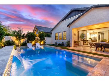 Beautiful backyard oasis featuring a sparkling pool and seamless indoor/outdoor lifestyle at 851 E Deer Creek Rd, Phoenix, AZ 85048