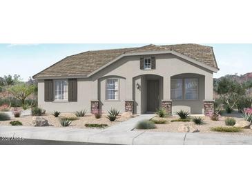 Charming single-story home featuring a neutral color palette, desert landscaping, and a welcoming front entrance at 14592 W Sand Hills Rd, Surprise, AZ 85387