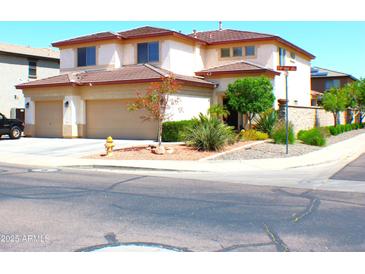 Inviting two-story home with desert landscaping, spacious garage, and manicured lawn on a corner lot at 15515 N 174Th Ave, Surprise, AZ 85388