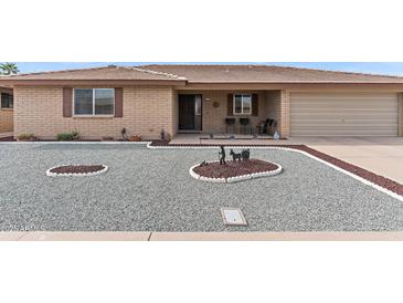 Charming single-story home featuring desert landscaping, a covered porch, and attached two-car garage at 8315 E Lobo Ave, Mesa, AZ 85209