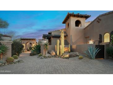 Stunning desert landscape design highlighting mature cacti, desert vegetation, and beautiful stone path at 11457 E Salero Dr, Scottsdale, AZ 85262