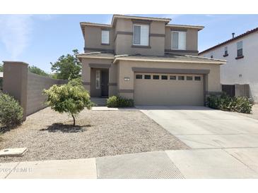 Two-story home features a two car garage, low maintenance yard, and neutral paint scheme at 1237 E Marcella Ln, Gilbert, AZ 85295