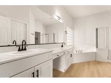 Elegant bathroom with dual sinks, quartz countertops, and separate tub at 1112 E Winged Foot Dr, Chandler, AZ 85249
