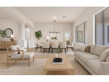 Bright and airy living room featuring hardwood floors, large windows, and an open floor plan at 1112 E Winged Foot Dr, Chandler, AZ 85249