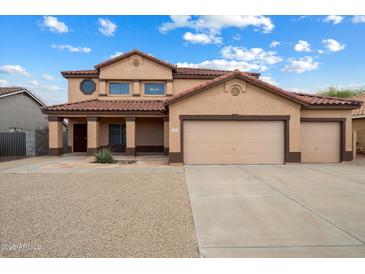 Inviting two-story home featuring a three-car garage and desert landscaping at 10551 W Jessie Ln, Peoria, AZ 85383