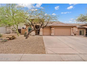 Charming single story home with a three car garage and desert landscaping at 10603 E Firewheel Dr, Scottsdale, AZ 85255
