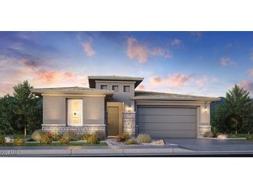 Beautiful single-story home showcasing modern architecture, desert landscaping, and a two-car garage at 11996 N Luckenbach St, Surprise, AZ 85388