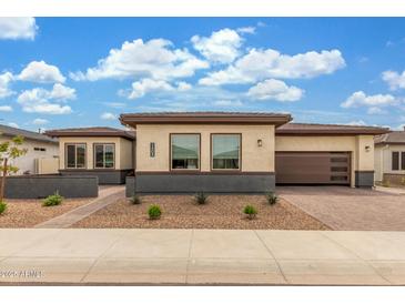 Stunning single story home featuring a symmetrical facade, low maintenance landscaping, and a two car garage at 1303 W Cherrywood Dr, Queen Creek, AZ 85140