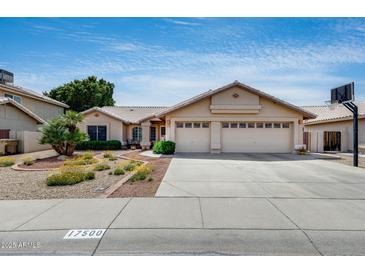 Charming single-story home with a three-car garage and a well-manicured desert front yard at 17500 N 85Th Dr, Peoria, AZ 85382