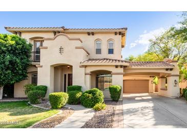 Stunning two-story home featuring stucco siding, a tile roof, manicured landscaping, and a porte-cochère at 3683 E Nolan Dr, Chandler, AZ 85249
