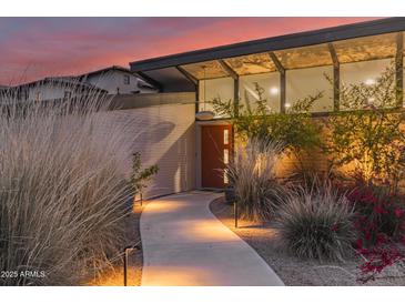 Contemporary home featuring a walkway to a bright orange front door, xeriscaping, and clerestory windows at 5960 E Orange Blossom Ln, Phoenix, AZ 85018