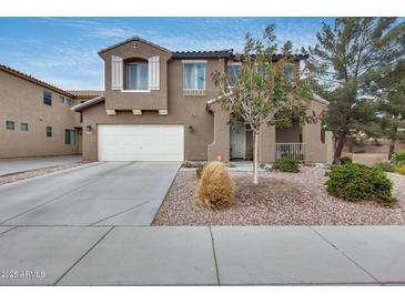 Charming two-story home with a two-car garage and a well-maintained front yard at 9364 W Cordes Rd, Tolleson, AZ 85353