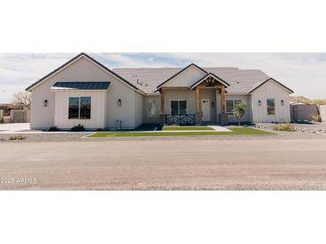 Charming home featuring a welcoming entrance and beautifully manicured artificial lawn at 1228 N 106Th Pl, Mesa, AZ 85207