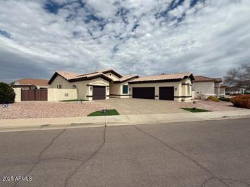 Single story home featuring a three car garage and low maintenance landscaping at 13196 W Coronado Rd, Goodyear, AZ 85395