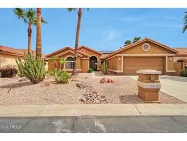 Charming single-story home boasts a xeriscaped front yard, desert landscaping, and a two-car garage at 15834 W Avalon Dr, Goodyear, AZ 85395