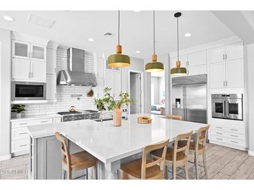 Bright kitchen with stainless steel appliances, white cabinetry, and a large island at 3842 E Fountain St, Mesa, AZ 85205