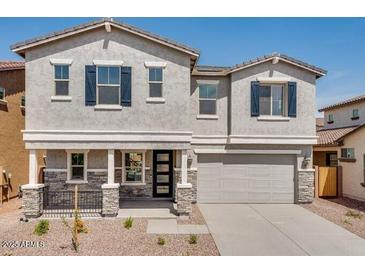 Charming two-story home with a well-maintained yard, a two-car garage, and a welcoming front porch at 8240 E Quintuplet Ave, Mesa, AZ 85212