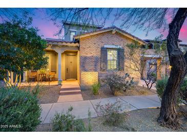 Beautiful brick home with a well-manicured front yard, desert landscaping, and a covered porch at 9439 E Trailside Vw, Scottsdale, AZ 85255