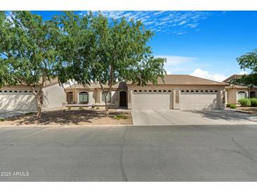 Charming single-story home with three-car garage and beautifully landscaped front yard at 10960 E Monte Ave # 169, Mesa, AZ 85209
