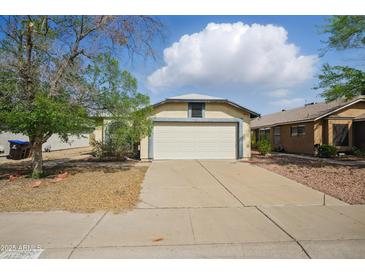 Charming single-story home featuring a neutral color scheme, two-car garage and mature trees in a well-maintained landscape at 11815 N 75Th Ln, Peoria, AZ 85345