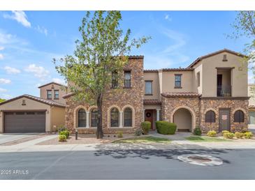 Charming two-story home featuring a stone facade, arched entryway, and well-manicured landscaping at 4777 S Fulton Ranch Blvd # 1029, Chandler, AZ 85248