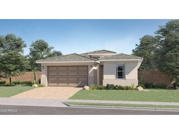 Charming single-story home with a two-car garage, neutral color palette and neatly landscaped front yard at 5075 S 233Rd Dr, Buckeye, AZ 85326