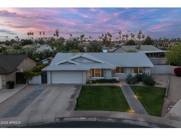 Charming single-story home featuring a well-manicured front yard and an attached two-car garage at 5206 S Clark Dr, Tempe, AZ 85283