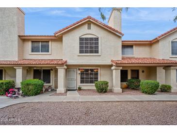 Inviting two-story townhouse featuring a red tile roof and a well-maintained stucco facade at 5808 E Brown Rd # 140, Mesa, AZ 85205