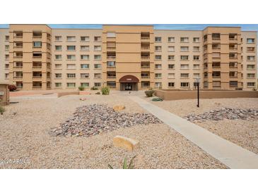 Multi-level condo building featuring balconies, desert landscaping, and covered entry at 7960 E Camelback Rd # 110, Scottsdale, AZ 85251